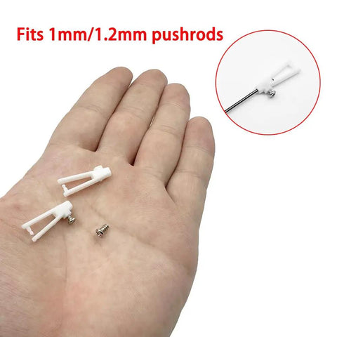 Hand holding White Plastic Clevis Set, 20 Pack With Screws, 21mm Clevis For RC Airplane, fits 1mm/1.2mm pushrods