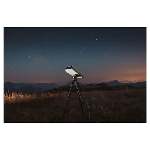 Smartphone Based Telescope Ultimate Pack With Interactive Sky Map And 30mm Aperture set up for stargazing at night in a field.