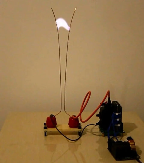 Mini DC Induction Jacobs Ladder High Voltage Arc Tesla Coil Kit for DIY enthusiasts in action, showing arcing effect.