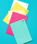 Colored paper sheets with holes made by Multi Size Hole Punch For Leather, Paper, Fabric And More Rotates Through Five Hole Sizes