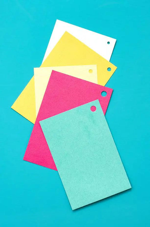 Colored paper sheets with holes made by Multi Size Hole Punch For Leather, Paper, Fabric And More Rotates Through Five Hole Sizes