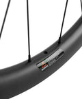 Close-up of Gravel Carbon Wheelset 700C Tubeless Rim Braking with spokes and warning label, matte finish, 12x142 hub compatibility.