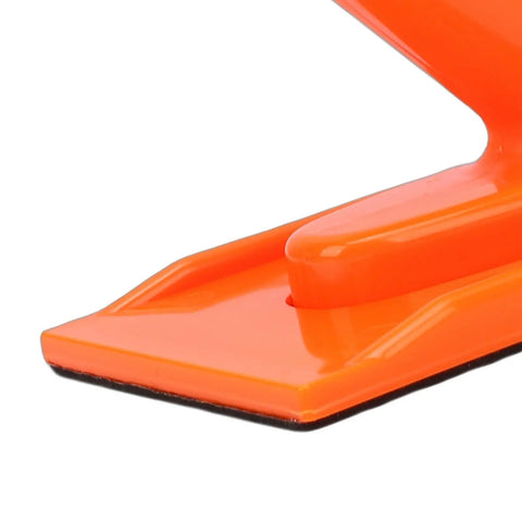 Close-up of Ergonomic Push Block And Stick Set for table saw with Pro Grade Non Slip Tilted Handle and safety texture in orange.