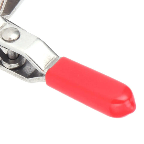 Rock Solid Toggle Clamp Featuring Tough As Nails 133 Pound Holding Capacity And Ergonomic Handle close-up of red plastic handle and steel pivot.