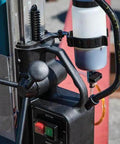 Makita HB350 magnetic drill, 1-3/8 in capacity, side view with coolant bottle.