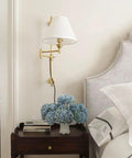 Classic Swing Arm Wall Sconce Featuring Distressed Bronze Finish One Light Adjustable Vanity Lamp 10 By 29 Inches Rustic Home Decor Absolutely Gotta Get beside a nightstand with hydrangea bouquet.