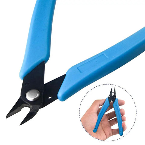 Close-up of blue-handled nippers from the 15 Piece Model Tools Kit For Gundam And Car Models, Pro Hobby Craft Set, held in hand