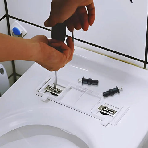 Person using a screwdriver to install Solid Brass Core Expanding Rubber Screw Bolts For Universal Top Mount Toilet Seats Blind Hole Quick Replacement Hardware Kit Four Piece Set.