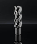 Annular cutter with spiral flutes, 15/16 in diameter, 2 in depth of cut, Weldon shank, upright on a reflective black surface