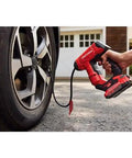 Person using V20 Cordless Tire Inflator And Portable Air Compressor With Digital Pressure Gauge Up To 150 Psi Quick On The Go Inflate for car tire.