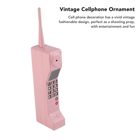 Kickass Vintage Cellphone Prop Cast From Heavy Duty Iron Serving Major Eighties Brick Phone Throwback Aesthetic view of pink vintage cell phone ornament.