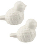 Slick White Ceramic Bird Toilet Bolt Covers hiding exposed flange nuts, decorative glossy bird caps for quick bathroom upgrade.