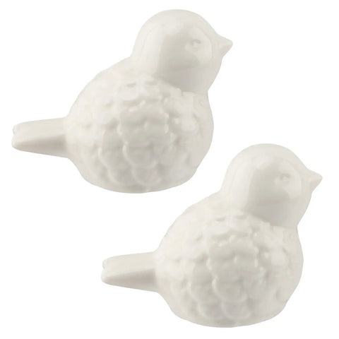 Slick White Ceramic Bird Toilet Bolt Covers hiding exposed flange nuts, decorative glossy bird caps for quick bathroom upgrade.