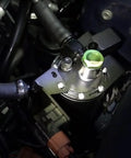 Yukofe Universal Air Oil Separator Catch Can installed in engine bay, black stainless steel construction preventing oil buildup.