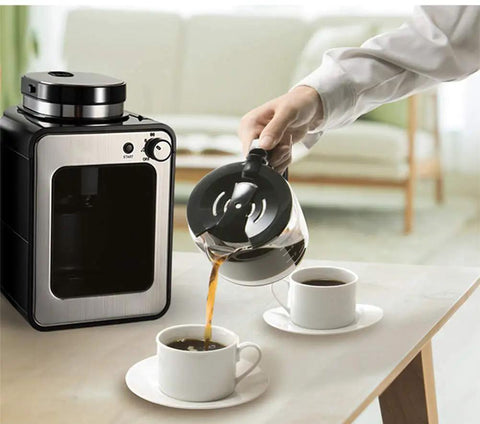 Compact Home Coffee Maker With Insulation And Built In Grinder Automatic Drip Brewer on a table next to coffee cups