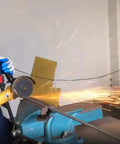 6-inch cut-off wheel on angle grinder cutting metal; blue bench vise and sparks.