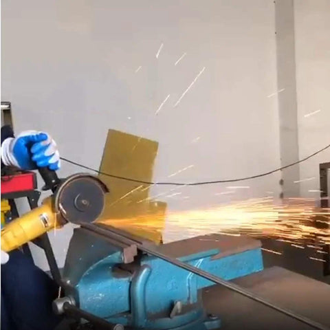 6-inch cut-off wheel on angle grinder cutting metal; blue bench vise and sparks.