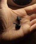 Hand holding Calmer Night Sleeping Ear Plugs Alternative, ultra soft silicone, designed for restful sleep without blocking sound.