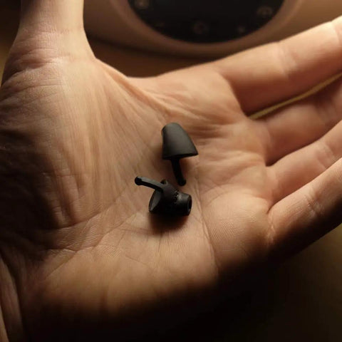 Hand holding Calmer Night Sleeping Ear Plugs Alternative, ultra soft silicone, designed for restful sleep without blocking sound.