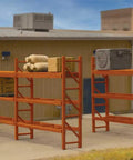 Top Shelf Sick Black HO Scale Pallet Rack Kit For Model Railroads And Custom Dioramas showing cargo storage with a figure.