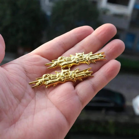 Close-up of gold alloy menuki from Dope Alloy Tsuba Fuchi Kashira Menuki Set For Samurai Sword Handle Upgrade 8 To 9 Cm Tsuba