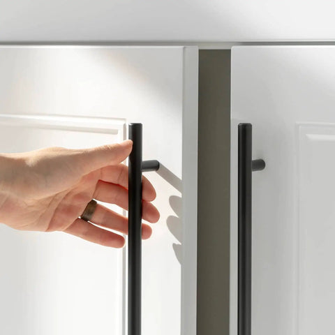Hand reaching for Five Pack 10 Inch Matte Black Cabinet Handles For Kitchen Cabinets And Dresser Drawers, Stainless Steel Pulls