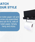 Wall-mounted sleek matte black toilet paper holder with shelf and drawer for XL rolls, including visible toilet paper and dispenser box.