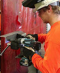 Rock Solid Eighteen Volt Cordless Hammer Driver Drill Kit Featuring Killer Torque Two Speed Gears And Hella Durable Ergonomic Build For Quick Drilling And Straight Up Fastening Projects Plus Long Lasting Battery Life used for drilling on metal in a workshop.