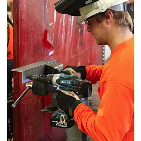 Rock Solid Eighteen Volt Cordless Hammer Driver Drill Kit Featuring Killer Torque Two Speed Gears And Hella Durable Ergonomic Build For Quick Drilling And Straight Up Fastening Projects Plus Long Lasting Battery Life used for drilling on metal in a workshop.