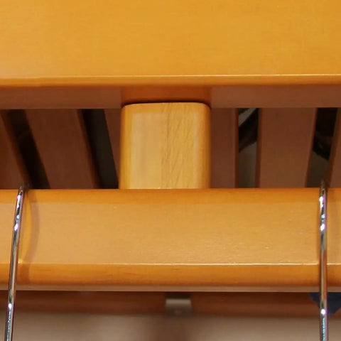 Close-up of heavy-duty metal hanging rod on Sweet Solid Wood Closet Organizer System With Slick Honey Maple Finish.