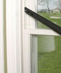 Black extension hose of the Upright and Canister Vacuum Extension Hose and Attachment Kit near a window frame.