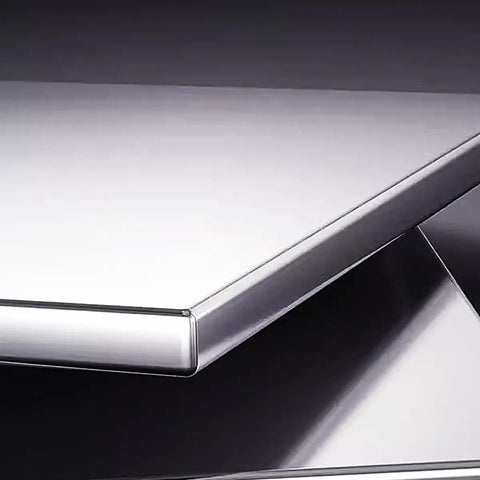 Close-up of the Rock Solid Stainless Steel Prep Table With Sliding Door Cabinet Heavy Duty Workbench top showing sleek surface and edges.