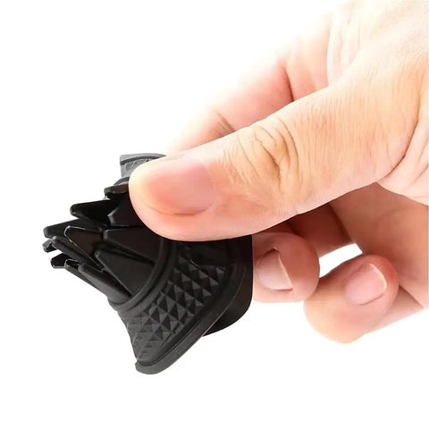 Tesla Cybertruck Wiper Hole Cover Pad Keeps Dang Leaves At Bay, held in hand, flexible black polymer, protects wiper components.
