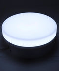 Awesome 360 Rotating Display Stand With Adjustable LED Lights And 11 Pounds Load Capacity, round LED light on smooth surface.