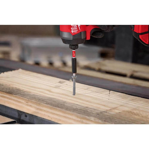 Milwaukee Shockwave impact driver driving a screw into a wooden plank