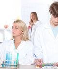 Students in lab coats studying with Laminated 8 By 11 Inches Periodic Table Poster With Elements, Symbols, And States Of Matter.
