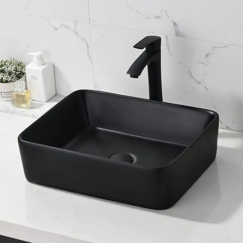 Modern black ceramic vessel sink with sleek faucet on marble countertop