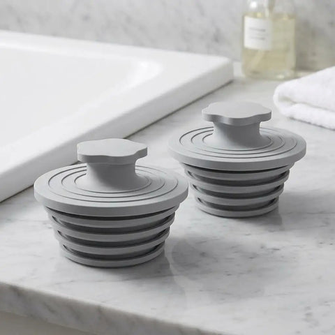 Happyyami Silicone Bathtub Drain 2 Pack Universal Gray Plug for 1.5-2 Inch, gray silicone plugs on marble countertop.