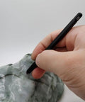 Solid Seven Piece Mohs Hardness Scratch Test Pens For Gemstone Checking Mineral ID, hand using pen on rock surface.