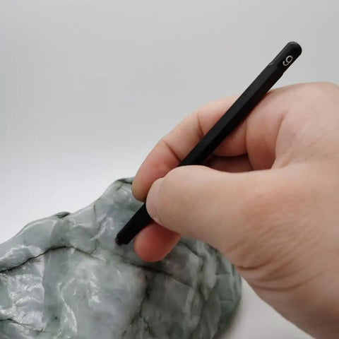 Solid Seven Piece Mohs Hardness Scratch Test Pens For Gemstone Checking Mineral ID, hand using pen on rock surface.