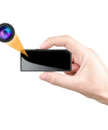 Hand holding Mini Spy Nanny Cam Body Camera 1080P Wearable Badge Style With Magnetic Clip and Brooch, showcasing lens detail.
