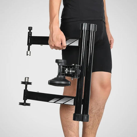 Person holding an Indoor Bike Trainer With Magnetic Resistance Foldable Portable Turbo Trainer Stand, showcasing foldable design.