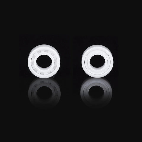 Front and side views of two white zirconia ceramic R188 bearings, miniature deep‑groove type.
