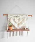 Set Of Four Top Shelf Wooden Dowel Closet Hangers With Burr Free Smooth Sandalwood Finish 12 Inch And 9 Inch Rods For Wardrobe Storage Durable Classic Design Garment Sticks That Keep Your Fits Looking Fresh And Neatly Packed with a macrame wall hanging and potted plant.