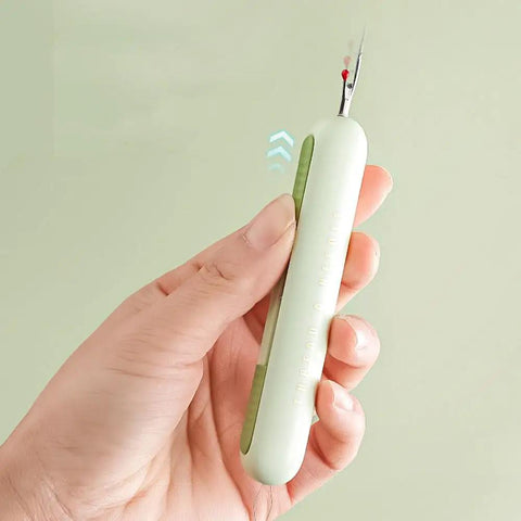 Close-up of a hand holding the 3 Pack 2 In 1 Needle Threader And Seam Ripper Set For Sewing Threading And Seam Removal Must Have Handy Tool.