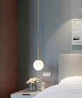 Bedroom setting with Plug In Globe Pendant Light With Frosted Glass Ball Shade, Easy To Install Ceiling Pendant For Dining Room, Bedroom Or Hallway, 17 Foot Cord, Soft Warm Glow For Cozy, Romantic Ambience And Modern Style, hanging beside bedside table.