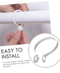 Close-up of hands installing white plastic curtain ring on rod, part of 60 Pack Plastic Curtain Rings For Rods Thick Durable Construction