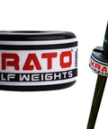 Close-up of a 4oz black golf swing trainer weight attached to a club shaft, featuring the 'KRATO Golf Weights' logo on the band.