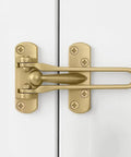 Tough Gold Swing Bar Door Lock For Swing In Doors Childproof Safety Latch on white doors with installation screws visible.