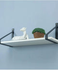 Steel Corner Bracket Wall Mounted Shelf Support Triangular Iron Brackets Set Of Two Black Metal Rack holding a white shelf with decor.